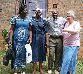 Barbara outside the vicarage being built by Mothers Union for Revd Appoloh Moyi and his wife, Alice